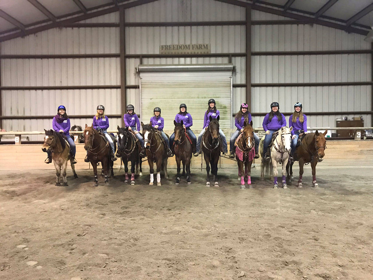 Sequim High School’s Washington State High School Equestrian Team prepares for their competition meets weekly at Freedom Farm’s indoor arena. Farm owners Mary Gallagher and Jerry Schmidt generously offer an evening to practice inside to the Port Angeles team, too. The Sequim team, from left, are Khelea Cloetens, Grace Niemeyer, Keri Tucker, Miranda Williams, Abby Garcia, Yana Hoesel, Abbi Priest, Lilly Thomas and Chloe VanProyen. (Katie Newton)