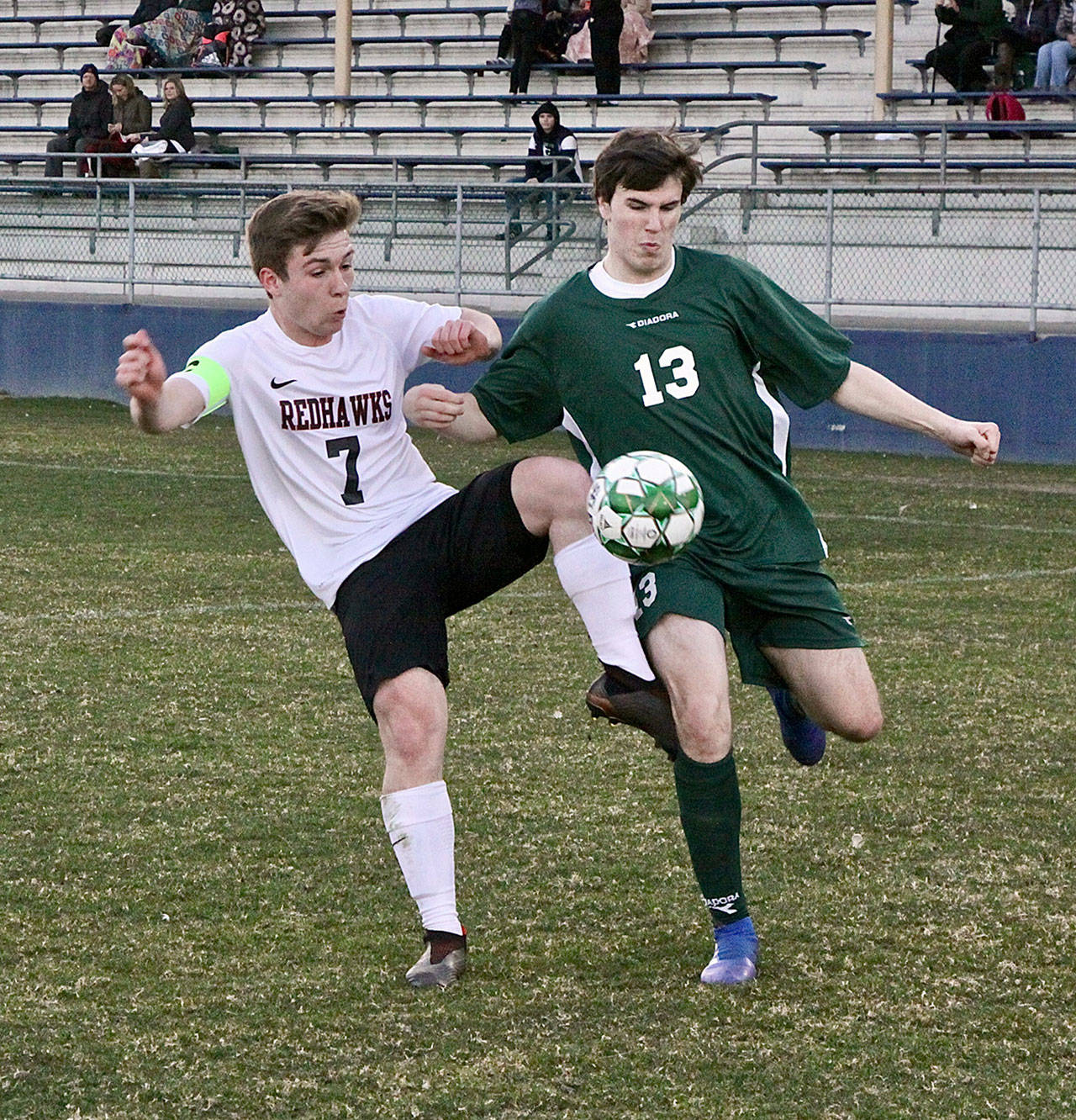 Port Townsendss Ian Kjeldgaard, left, and Port Angeless Stuart Methner vie for possession Monday night at Civic Field.                                Dave Logan/for Peninsula Daily News
