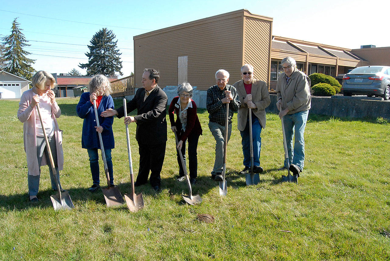 Volunteer Hospice of Clallam County officials, the architect and general contractor perform a ceremonial groundbreaking on Friday for a medical equipment and supplies storage building next to the organizations new offices at Eighth and Race streets in Port Angeles. Taking part in the ceremony were, from left, office manager Lyn Gilbert, patient care manager Bette Wood, Volunteer Hospice President Randy Hurlbut, volunteer service manager Astrid Raffinpeyloz, board secretary David Gilbert, Bill Lindberg of Lindberg and Smith Architects and Jim Miller of Sequim-based Miller Construction, Inc. (Keith Thorpe/Peninsula Daily News)