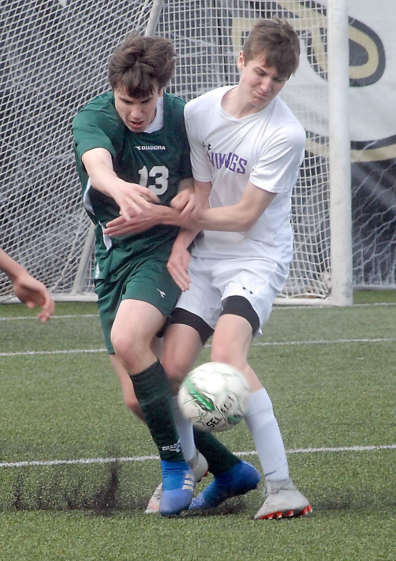 Port Angeles’ Stuart Methner, left, and North Kitsap’s Cameron Peaslee battle for the ball during Saturday’s match at Peninsula College in Port Angeles.                                Keith Thorpe/Peninsula Daily News