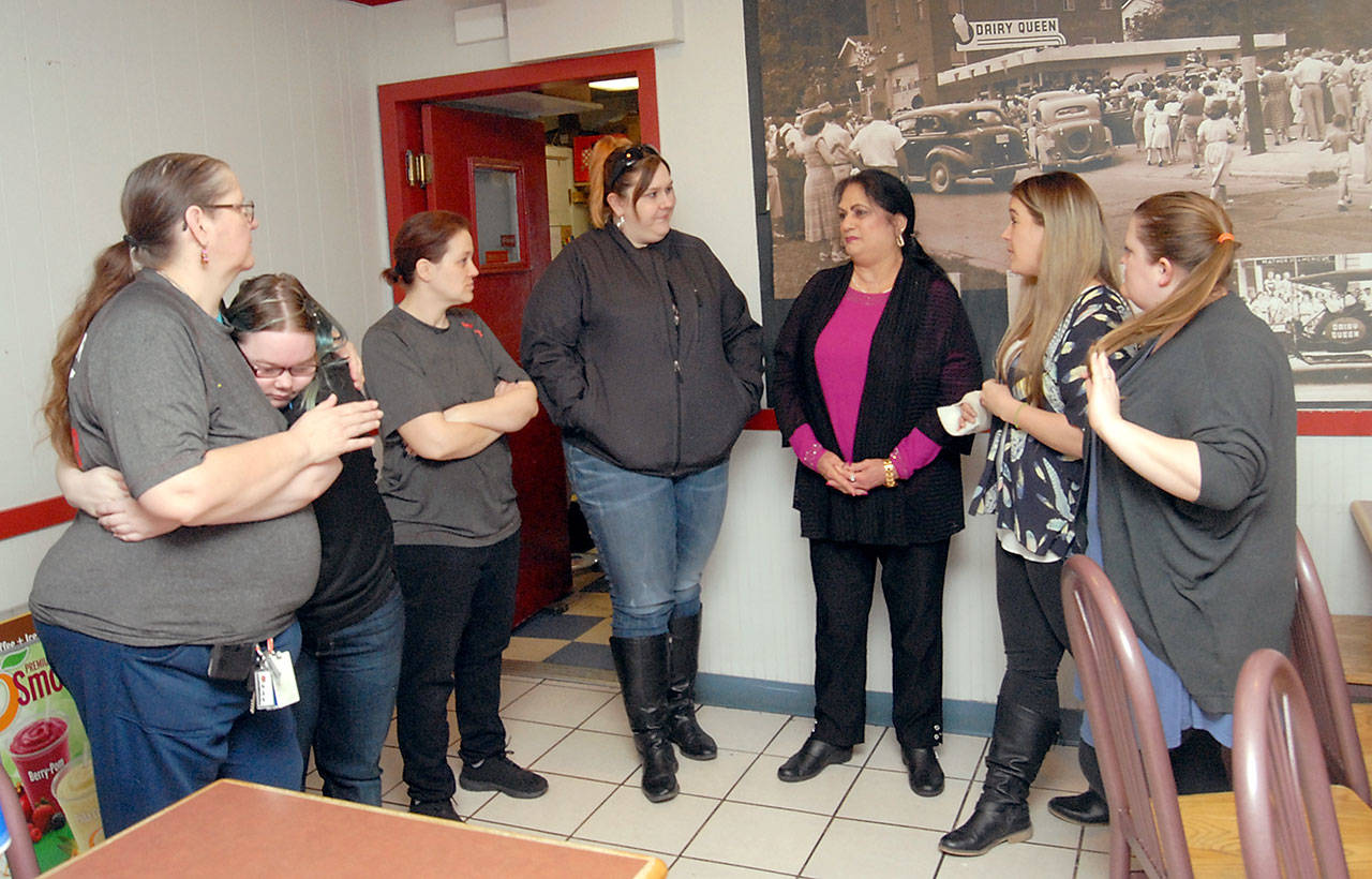 Current and former employees gather near a mural in the Port Angeles Dairy Queen on Tuesday, the last day of business on Railroad Avenue. Included were, from left, Patty Gardner, Shay Brandon, Jennifer Fischer, Melinda Bishop, business owner Kelly Sandhu, Tasha Kellen and Stacey Houk. (Keith Thorpe/Peninsula Daily News)