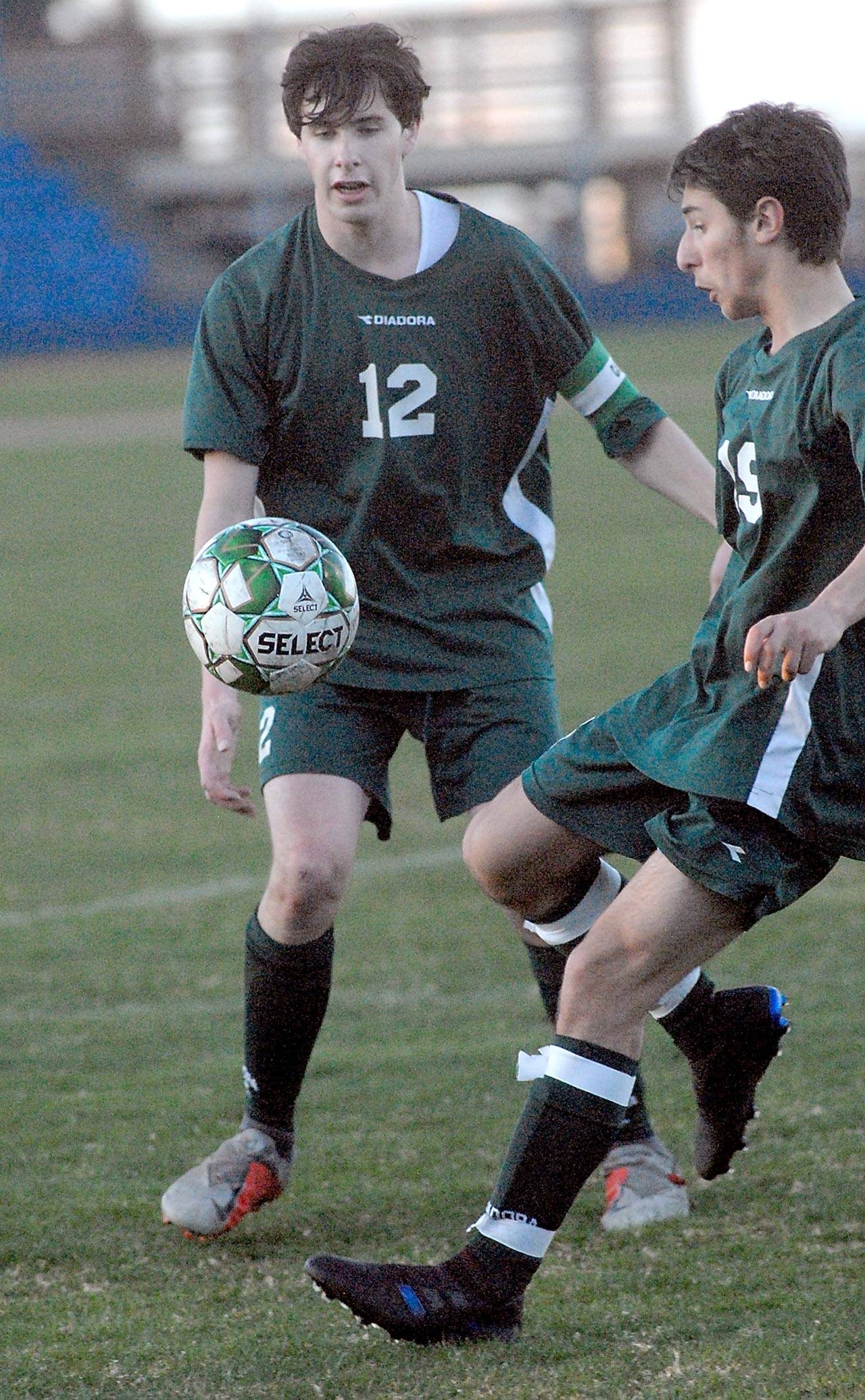 Keith Thorpe/Peninsula Daily News Port Angeles Andrew Methner, left, and Garrett Mahaney watch an incoming ball on Tuesday at Port Angeles Civic Field.