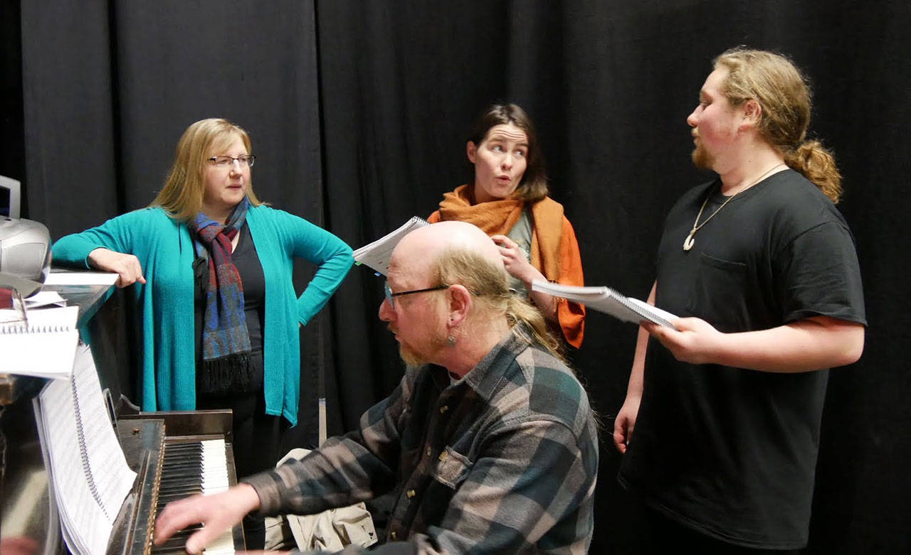 From left, director Christy Holy, Steven Humphrey (on piano), Emma Jane Garcia and Austin Krieg work on a duet in the wings during rehearsal for Olympic Theatre Arts’ “First Date.” (Olympic Theatre Arts)