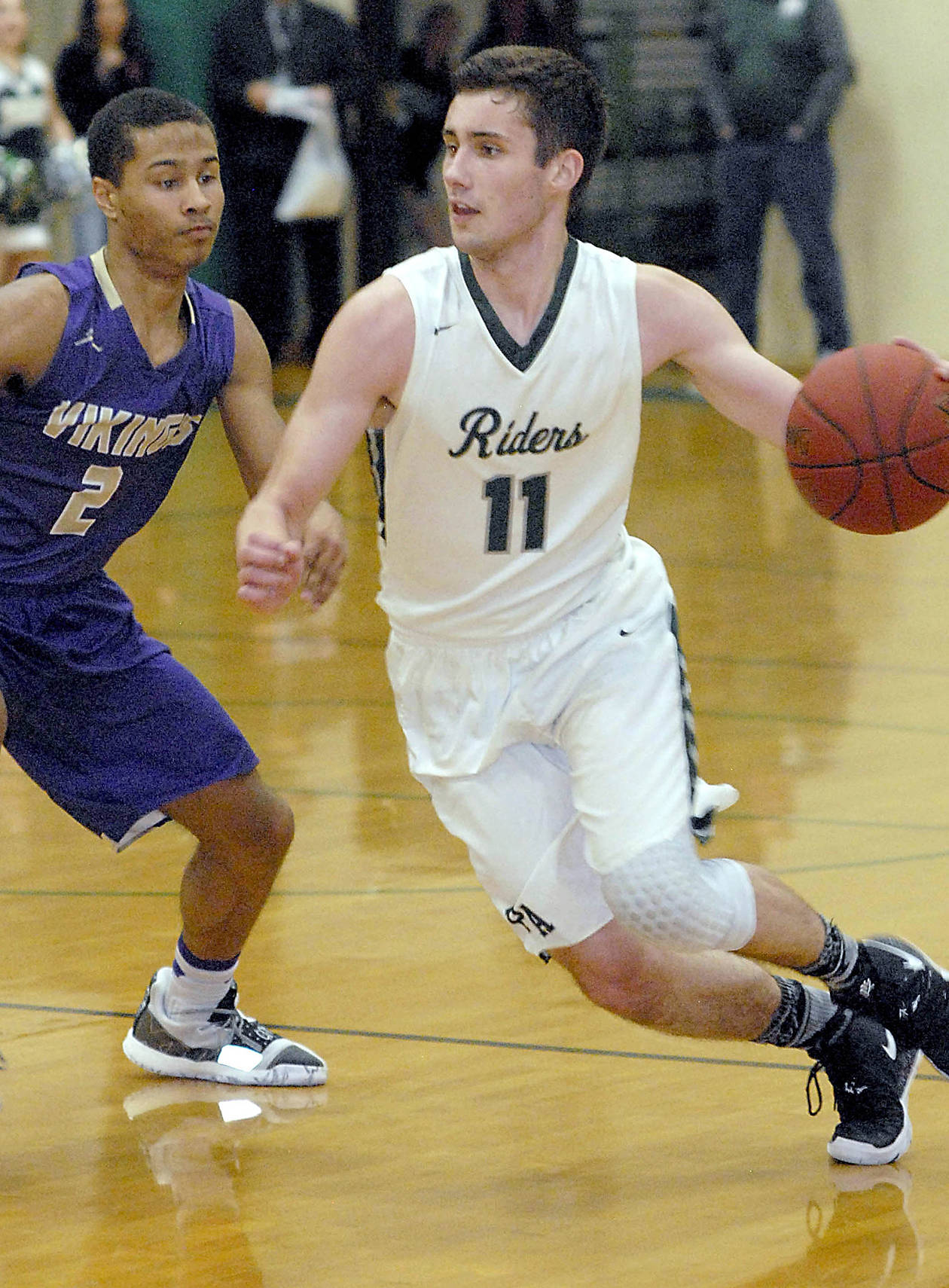 <strong>Keith Thorpe</strong>/Peninsula Daily News                                Port Angeles’ Kyle Benedict, right, sweeps past North Kitsap’s Kobe McMillian during a game in January in Port Angeles.