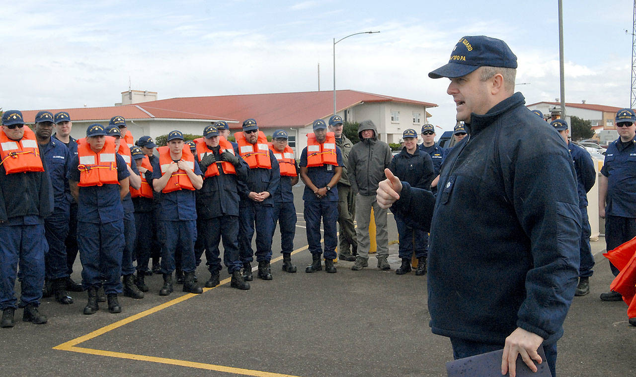Cmdr. Scott Jackson, commanding officer of U.S. Coast Guard Air Station/Sector Field Office Port Angeles, gives instructions to his crews about the importance of a rapid evacuation in the event of a Cascadia earthquake and subsequent tsunami during a drill at the base on Ediz Hook. (Keith Thorpe/Peninsula Daily News)