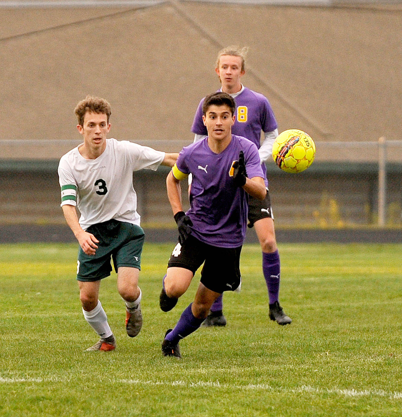 Port Angeles’ Andrew St. George, left, and Sequim’s Sean Weber battle for a loose ball while Weber’s teammate Michael McAleer is ready in the background Tuesday in Sequim. Sequim won the match 1-0 in what was a battle for first place in the Olympic League 2A Division. (Michael Dashiell/Olympic Peninsula News Group)