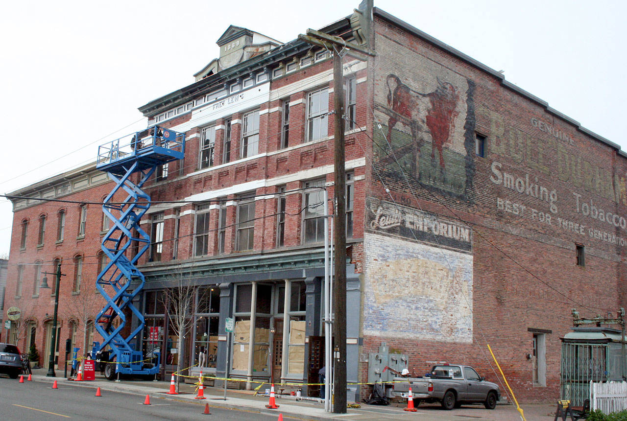 The historic Fred Lewis building on Water Street is getting a facelift this month with new architectural elements such as cornices. City building officials determined repairs needed to be done in order to make the building safe after years of storms damaged the facade. (Brian McLean/Peninsula Daily News)