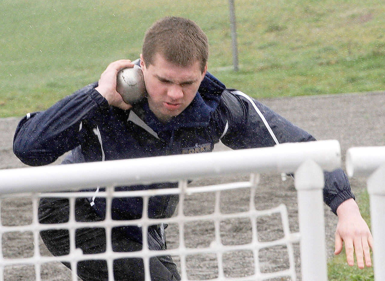 Lonnie Archibald/for Peninsula Daily News Forks’ Aaron Bennett competes in the shot put at the Forks Lions Club Invitational in Forks on Saturday. Bennett finished seventh with a distance of 29 feet, 3 1/2 inches.