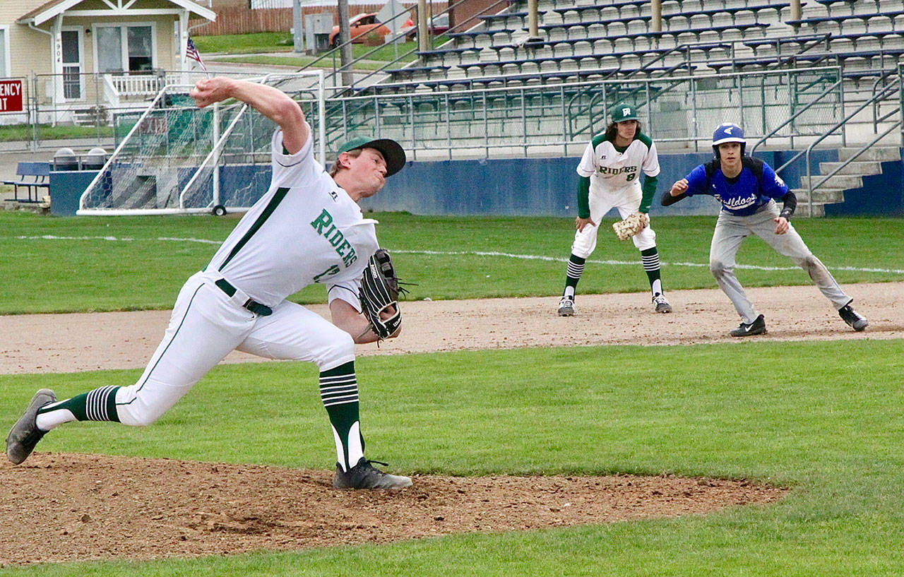 Port Angeles pitcher Ethan Flodstrom throws to the plate against North Mason on Monday. Flodstrom allowed no runs in three innings. North Masons Troy McCormick is watched carefully by the Port Angeles first baseman Bo Bradow. (Dave Logan/for Peninsula Daily News)