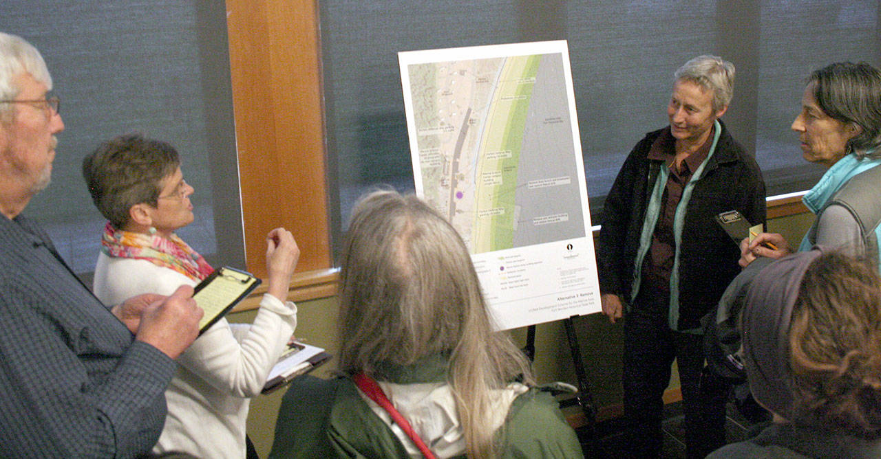 A small crowd gathered around posters Thursday that showed three different alternatives for the pier and the Marine Science Center at Fort Worden State Park. About 75 people attended the public meeting hosted at the Fort Worden Commons by the state Parks and Recreation Commission. (Brian McLean/Peninsula Daily News)