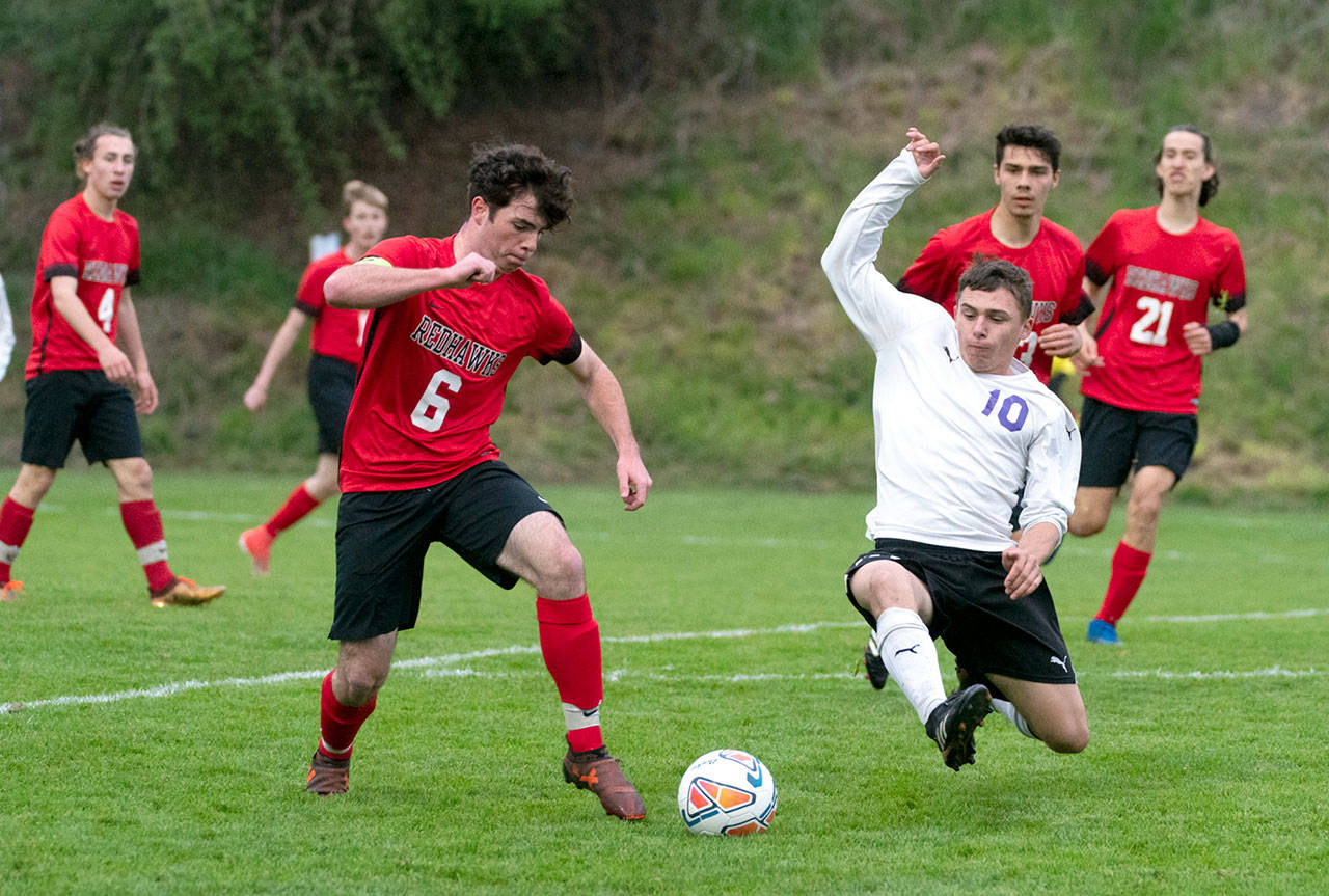 Port Townsend’s Zachary Dempsey, left, and Sequim’s Mathys Tanche vie for control in a game at Memorial Field in Port Townsend on Tuesday.                                Steve Mullensky/for Peninsula Daily News