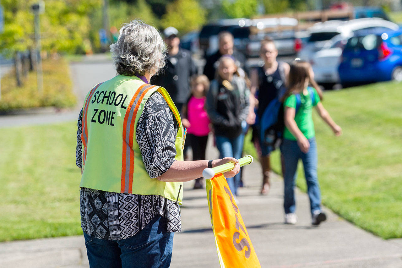 Robin Sheriff prepares to usher Jefferson Elementary students across Lincoln Street in Port Angeles on Monday. The state Legislature approved a bill Sunday that gives school districts the option to raise their levies again. (Jesse Major/Peninsula Daily News)