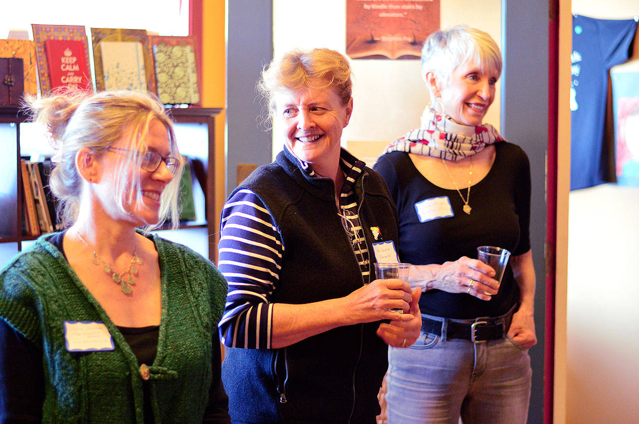A cross-section of local authors — including, from left, Julie Christine Johnson, Kaci Cronkhite and Louise Marley, pen name Louisa Morgan — gathered Saturday evening for Independent Bookstore Day at Port Townsend’s Writers’ Workshoppe/Imprint Books. (Diane Urbani de la Paz/for Peninsula Daily News)