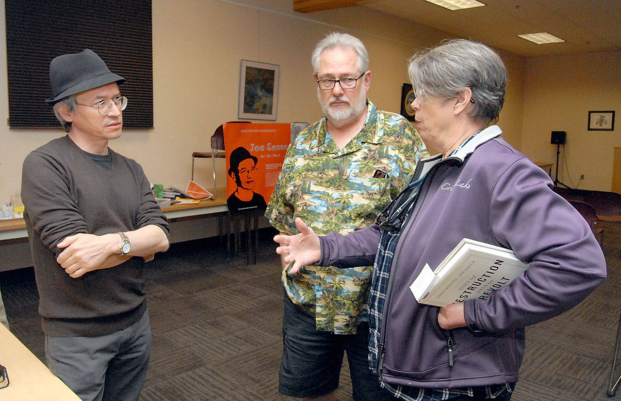 Author/illustrator Joe Sacco, left, meets with Brian Doerter and Gloria Moe of Port Angeles prior to Saccos presentation as a Peninsula College writer in residence on Wednesday at the Elwha Klallam Heritage Center in Port Angeles. (Keith Thorpe/Peninsula Daily News)