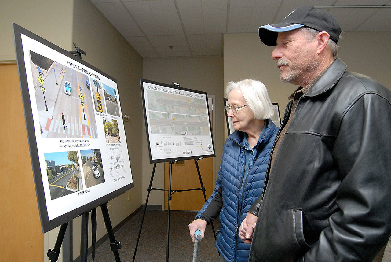 John Hayduk of Port Angeles, right, and his mother, Janet Hayduk, a long-time crossing guard at Jefferson School, look over proposals to resurface and reconfigure portions of Lauridsen Boulevard during a public open house on Wednesday at the Port Angeles Public Library. City planners listened to public suggestions and concerns about the project, which could include new turn lanes, street markings and improved pedestrian crosswalks. (Keith Thorpe/Peninsula Daily News)