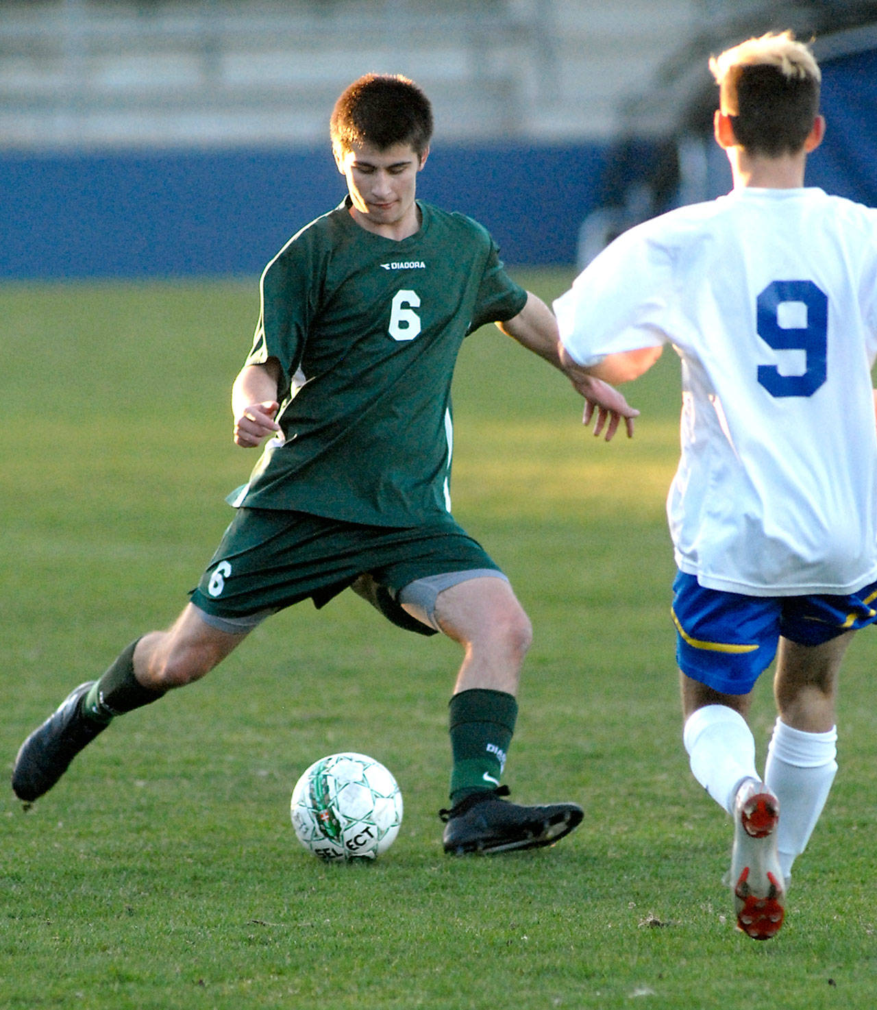 Keith Thorpe/Peninsula Daily News Port Angeles’ Kaleb Baier, left, tries to avoid the defense of Bremerton’s Jeremy Ford during a match in March.