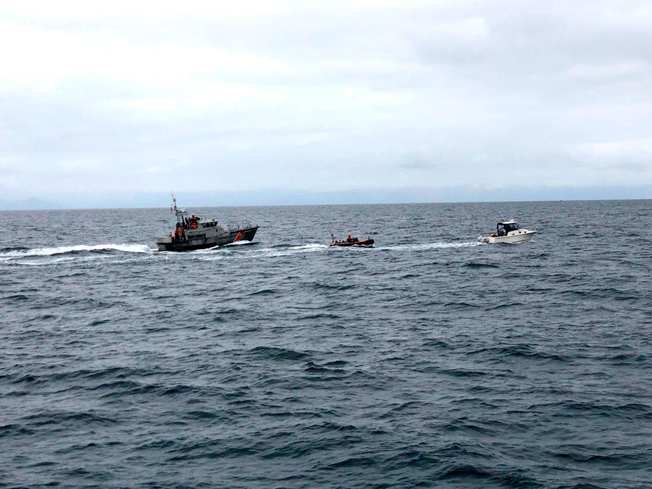 Coast Guard crew members aboard a 47-foot Motor Life Boat from Station Neah Bay, and aboard the deployable craft of the Coast Guard cutter Wahoo, intercept and aid a 33-foot recreational vessel reportedly taking on water 25 nautical miles southwest of Neah Bay. (Cutter Wahoo/U.S. Coast Guard)