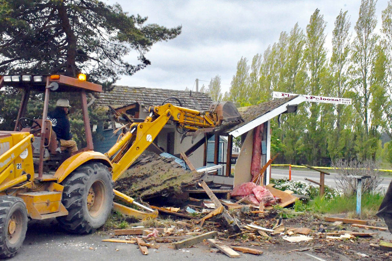Port Townsend’s “Old Blue” Visitor’s Information Center on Sims Way met its fate Thursday when Port of Port Townsend employees took down the structure that had been deteriorating in place for several years. (Jeannie McMacken/Peninsula Daily News)