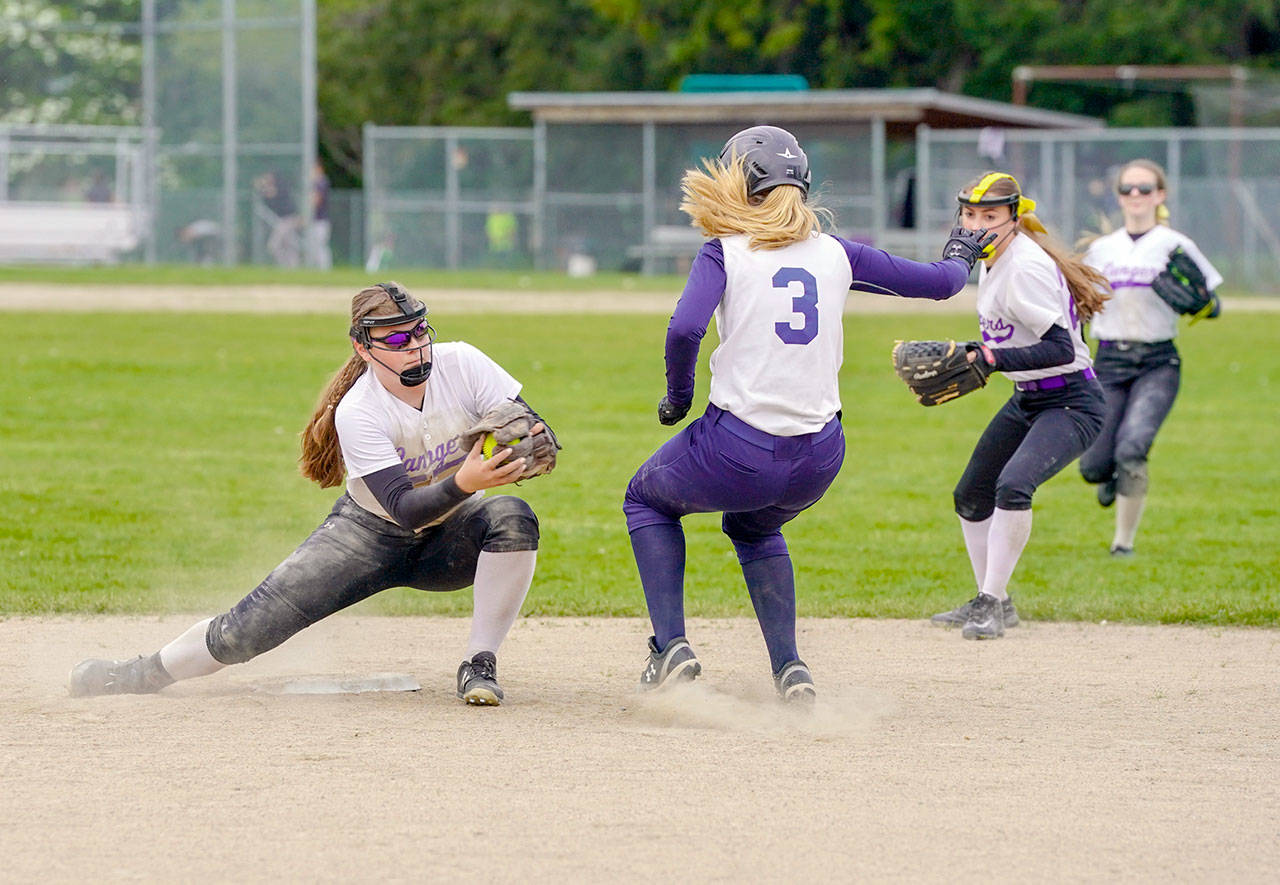 Steve Mullensky/for Peninsula Daily News Quilcene’s Madison Coffey, left, guards second base and gets the out on Pope John Paul II’s Lauryn Johnson during a SeaTac League game in Quilcene on Thursday.