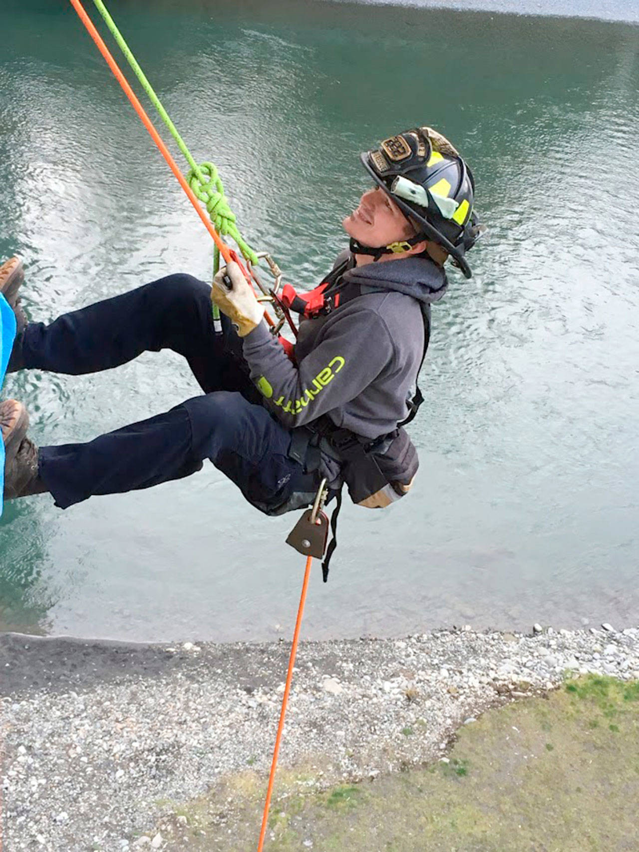 Firefighter/EMT Tyler Gear rappels off the Elwha River Bridge during technical rescue training.