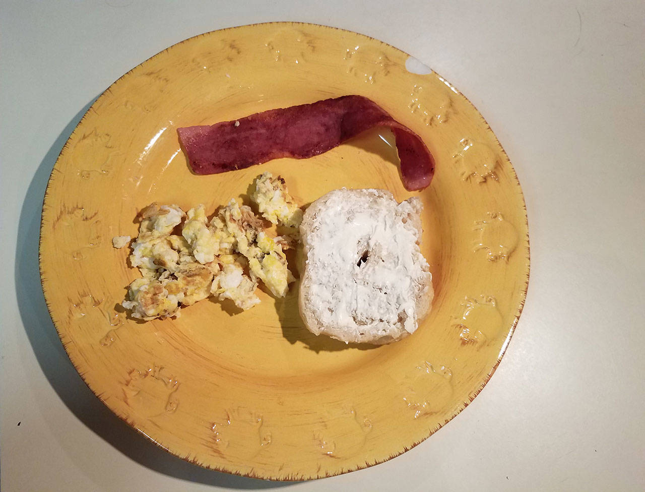 Half of a fresh, homemade bagel with scrambled eggs and turkey bacon makes for a delicious breakfast. (Emily Hanson/Peninsula Daily News)
