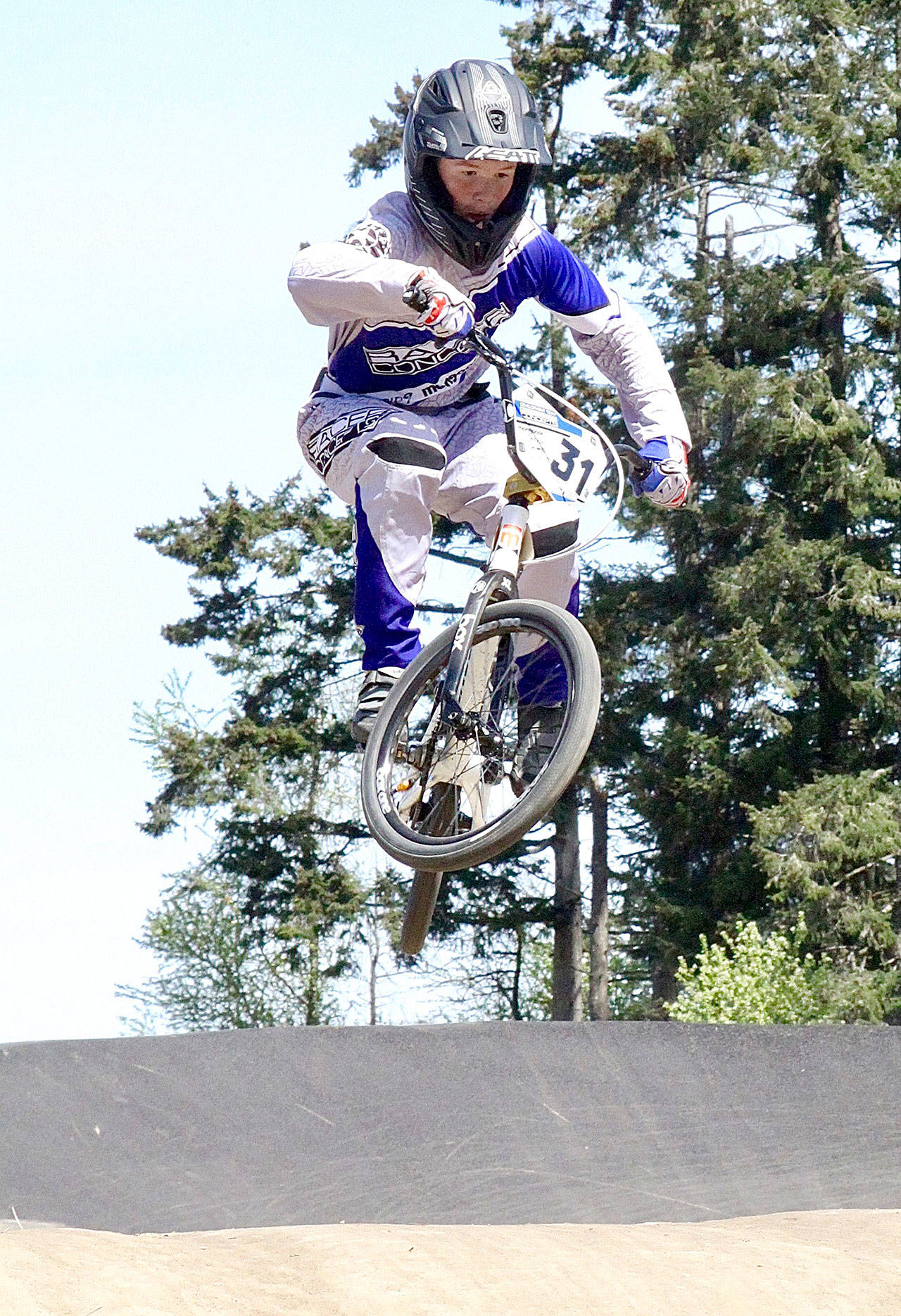 With a newly refurbished track and new fencing and entrance it was fun in the sun for the BMX racers at Lincoln Park on the first day of racing Sunday. Brian Belbin of Port Angeles does an extra twist with his handlebars as flies over the hills at the track. (Dave Logan/for Peninsula Daily News)