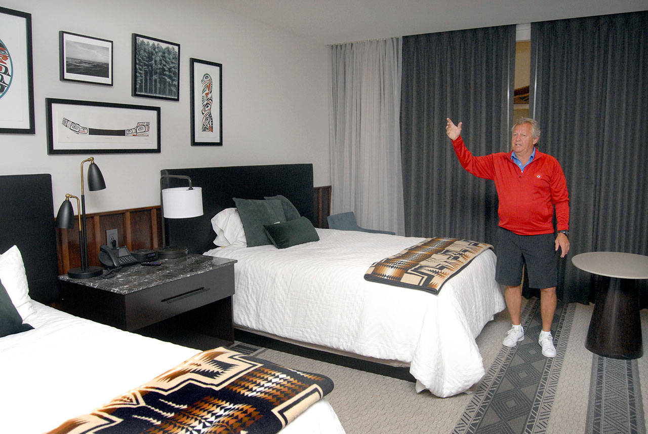 Jerry Allen, chief executive officer for 7 Cedars Casino, describes the choice of decor Saturday in a mockup guest room that will be typical of the guess offerings in a resort hotel under construction in Blyn. (Keith Thorpe/Peninsula Daily News)