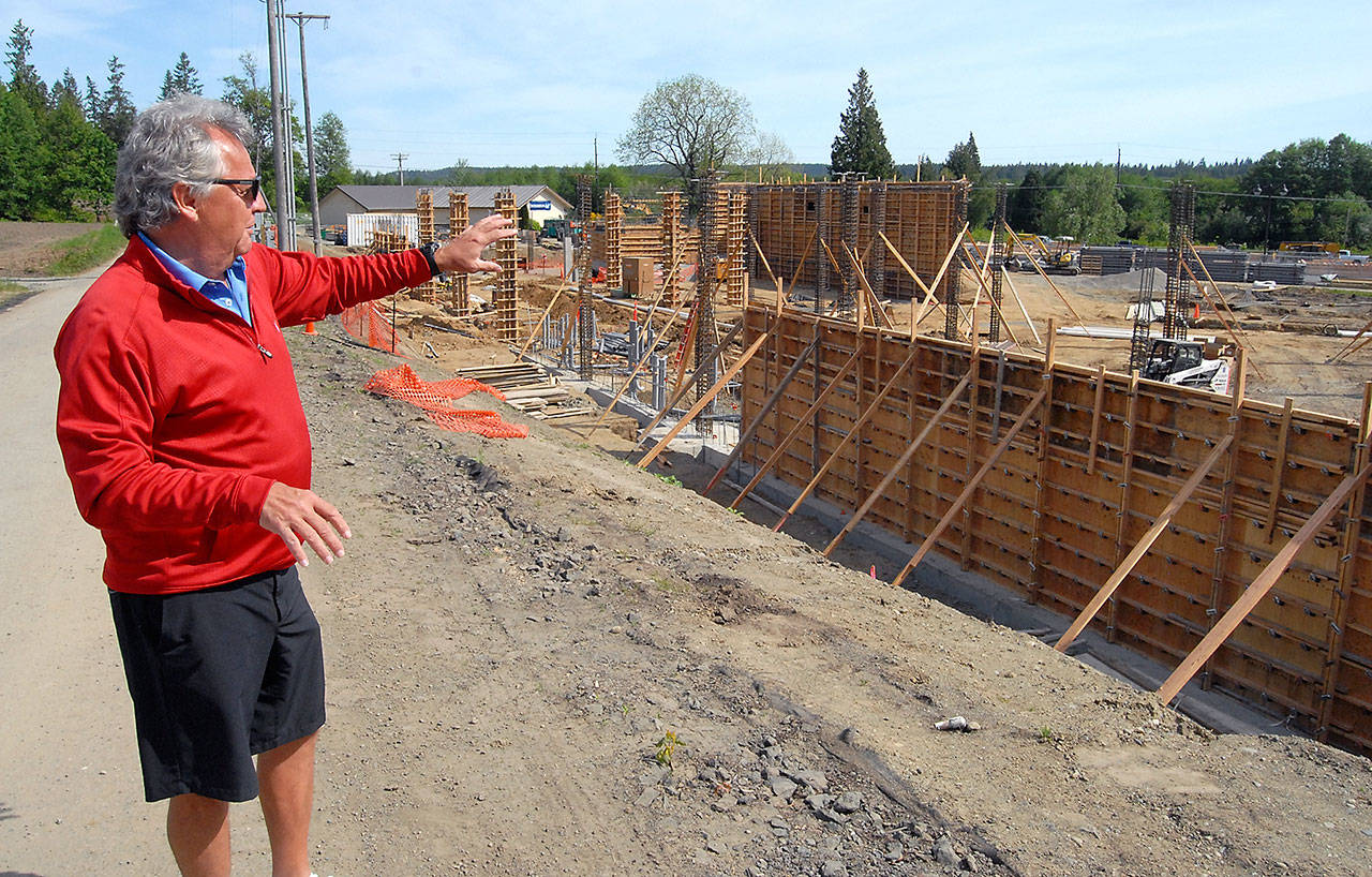 7 Cedars Casino chief executive officer Jerry Allen points on Saturday to the status of construction of the casino’s new 100-room resort hotel next to the casino in Blyn. (Keith Thorpe/Peninsula Daily News)