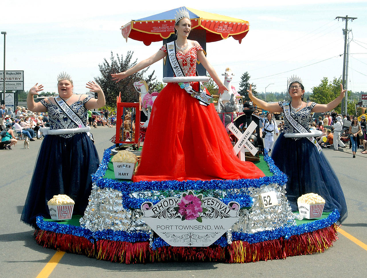 The 2019 Rhododendron Festival royalty, from left, Princess Kaylee Krajewski, Queen Mary Neville and Princess Ellie Thornton ride on their float during Saturday’s Irrigation Festival in Sequim. (Keith Thorpe/Peninsula Daily News)