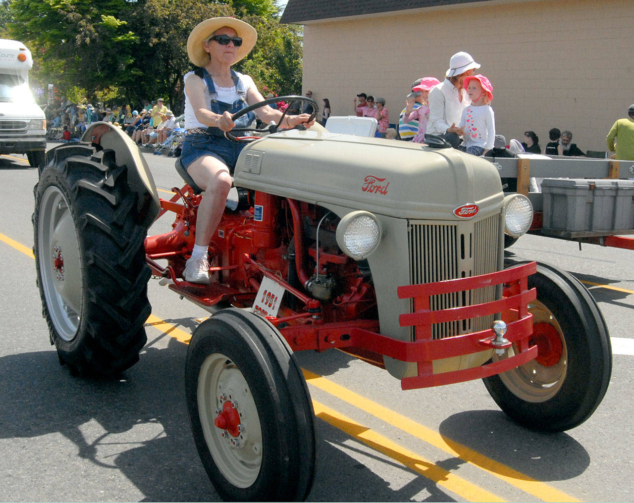 Kay Emmeret drives a vintage 1951 Ford tractor as part of a parade entry for Lonnie Love. (Keith Thorpe/Peninsula Daily News)