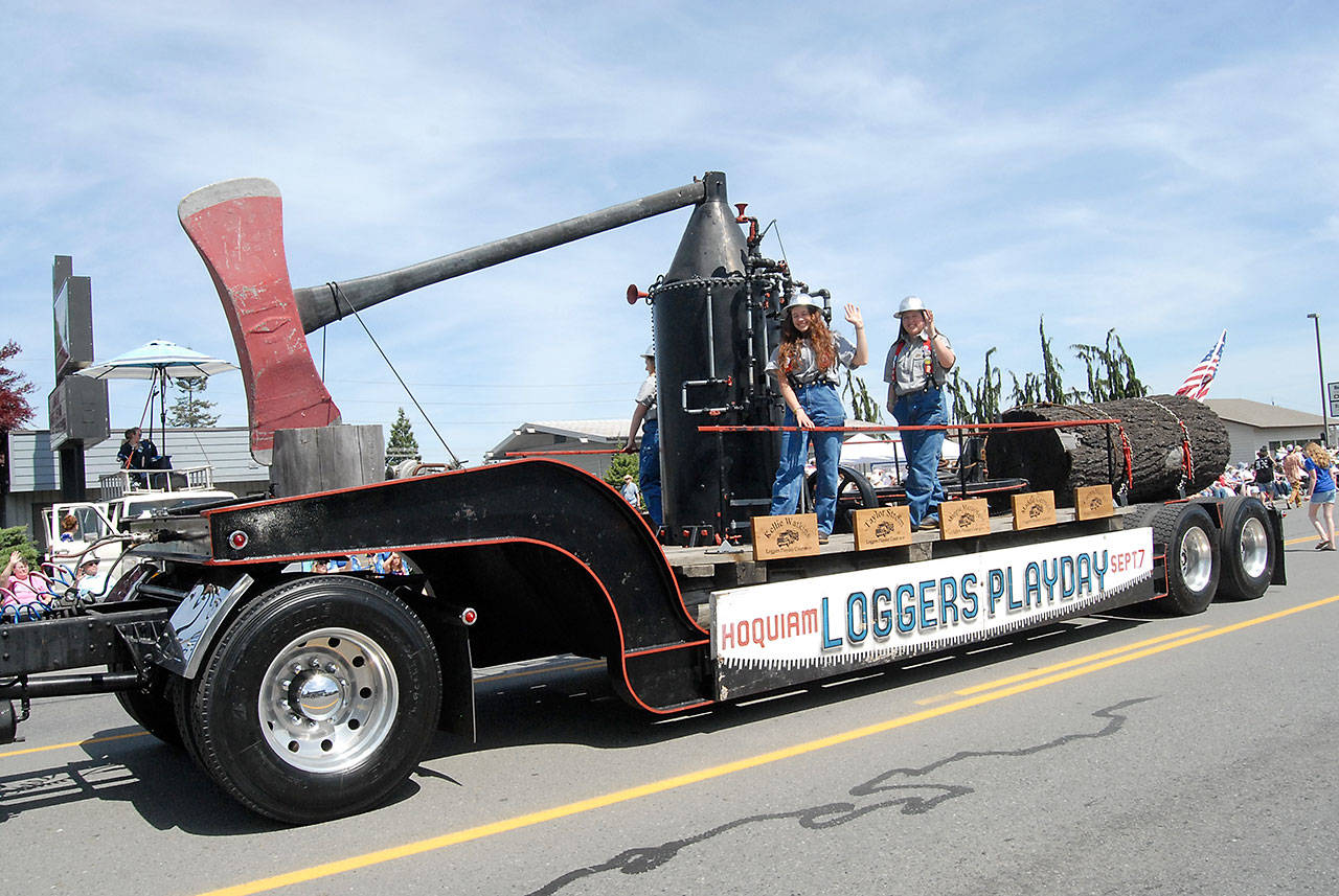 A float representing the Loggers Play Day in Hoquiam makes its way down the parade route. (Keith Thorpe/Peninsula Daily News)