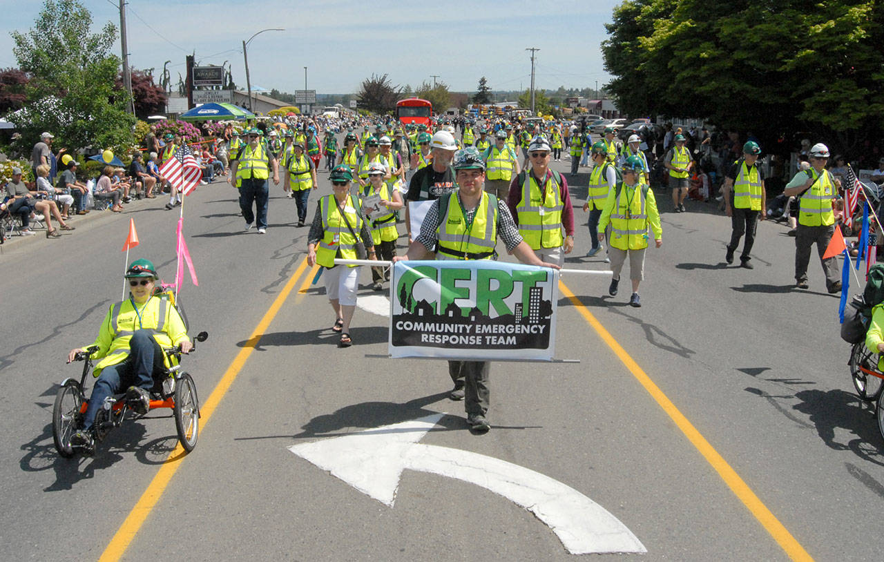 Members of the Clallam County Community Emergency Response Team wear yellow safety vests as they ply the parade route. (Keith Thorpe/Peninsula Daily News)