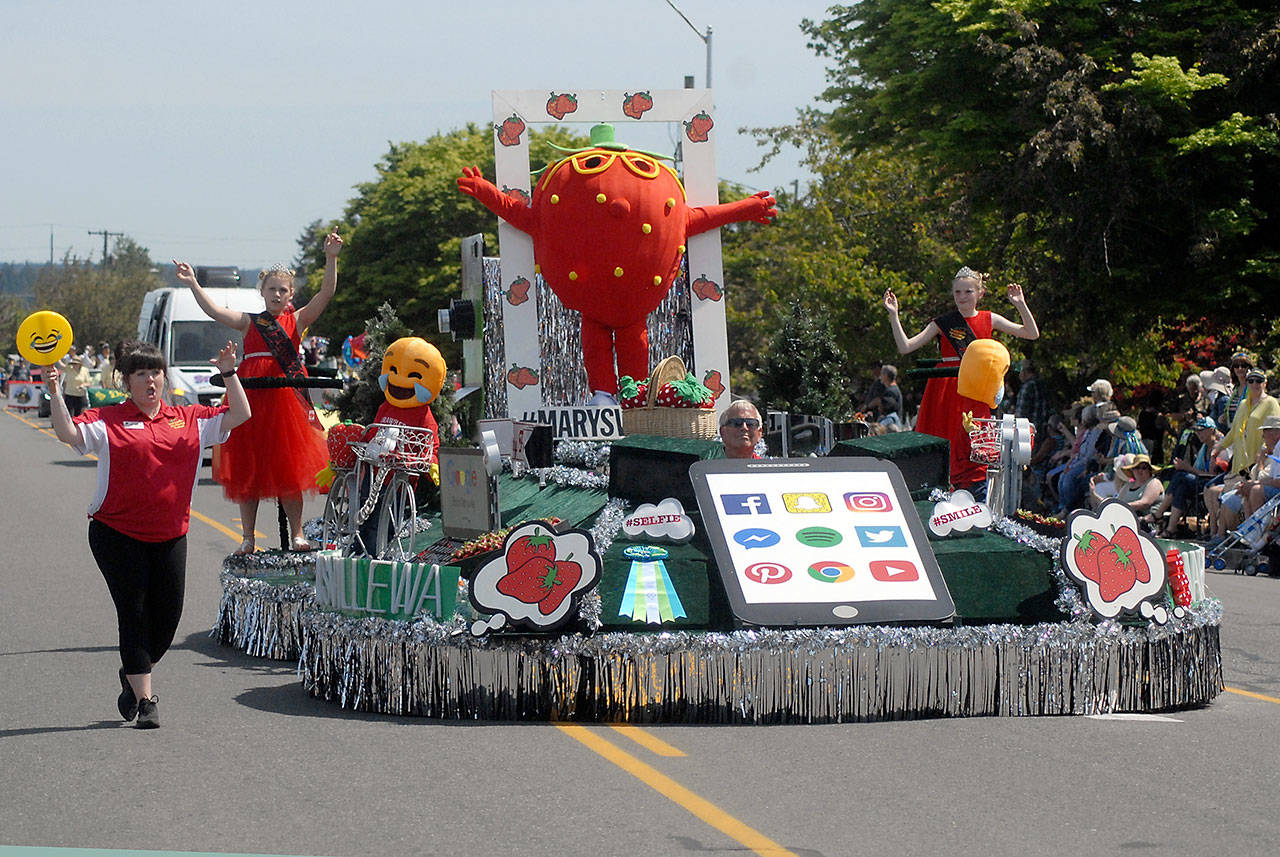A float representing the Marysville Strawberry Festival rolls down the parade route on Saturday. (Keith Thorpe/Peninsula Daily News)