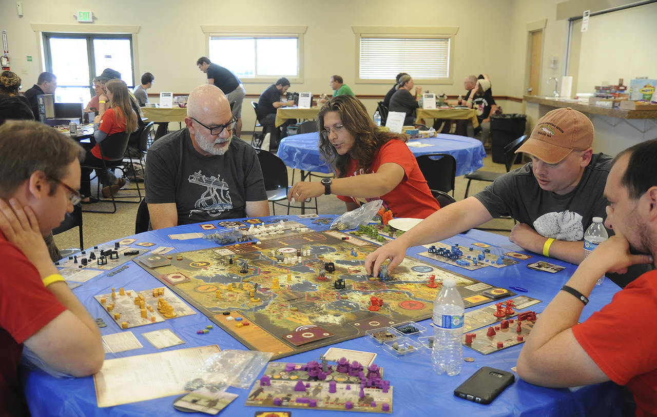 Gamers of all ages enjoying a board game session at Opttacon 2018. (Michael Dashiell/Olympic Peninsula News Group)
