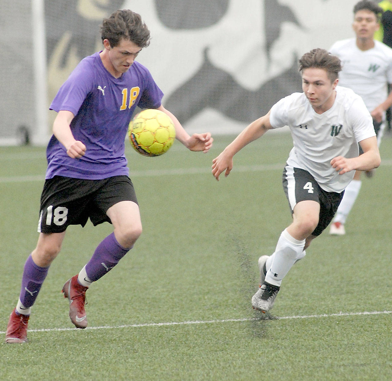 <strong>Keith Thorpe</strong>/Peninsula Daily News                                Reid Parker of Sequim, left, tries to outrace Woodland’s J.J. Fuerst in Wednesday’s night’s playoff game at Peninsula College.