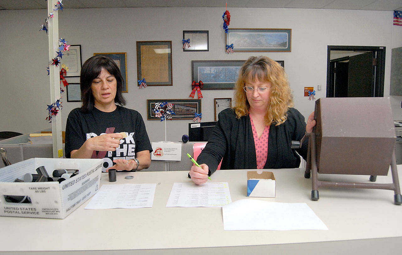 Susan Johnson of the Clallam County Auditors Office, left, reads names drawn by lot as Elections Manager Becky Pettigrew records the order that candidates will appear on the ballot during Friday’s lot draw at the Clallam County Courthouse in Port Angeles. (Keith Thorpe/Peninsula Daily News)