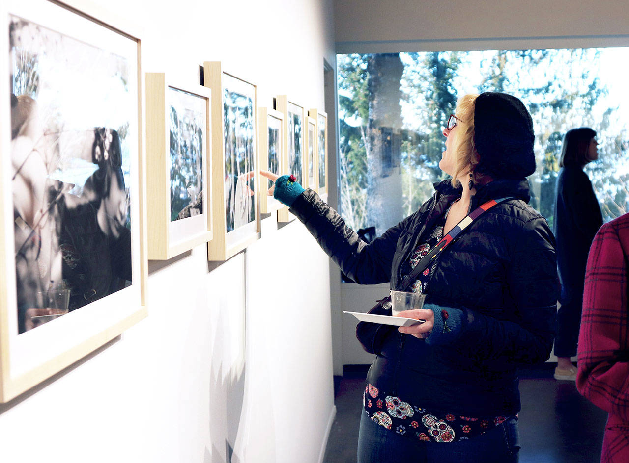 Jeanette Painter of Port Angeles admires a recent exhibit at the Port Angeles Fine Arts Center. The nonprofit center is changing the offerings in its indoor gallery and outdoor sculpture park. (Port Angeles Fine Arts Center)