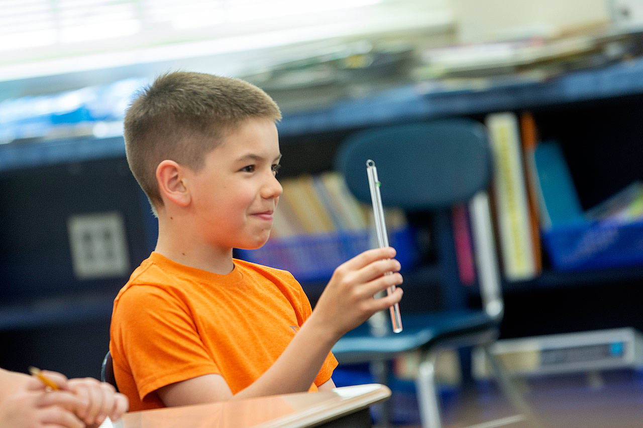 Fourth-grade student Josh Freeman shows state Rep. Mike Chapman his reusable straw. Fourth-grade students at Jefferson Elementary School have been researching the impact disposable straws have on the environment and have been in contact with Chapman’s office. (Jesse Major/Peninsula Daily News)