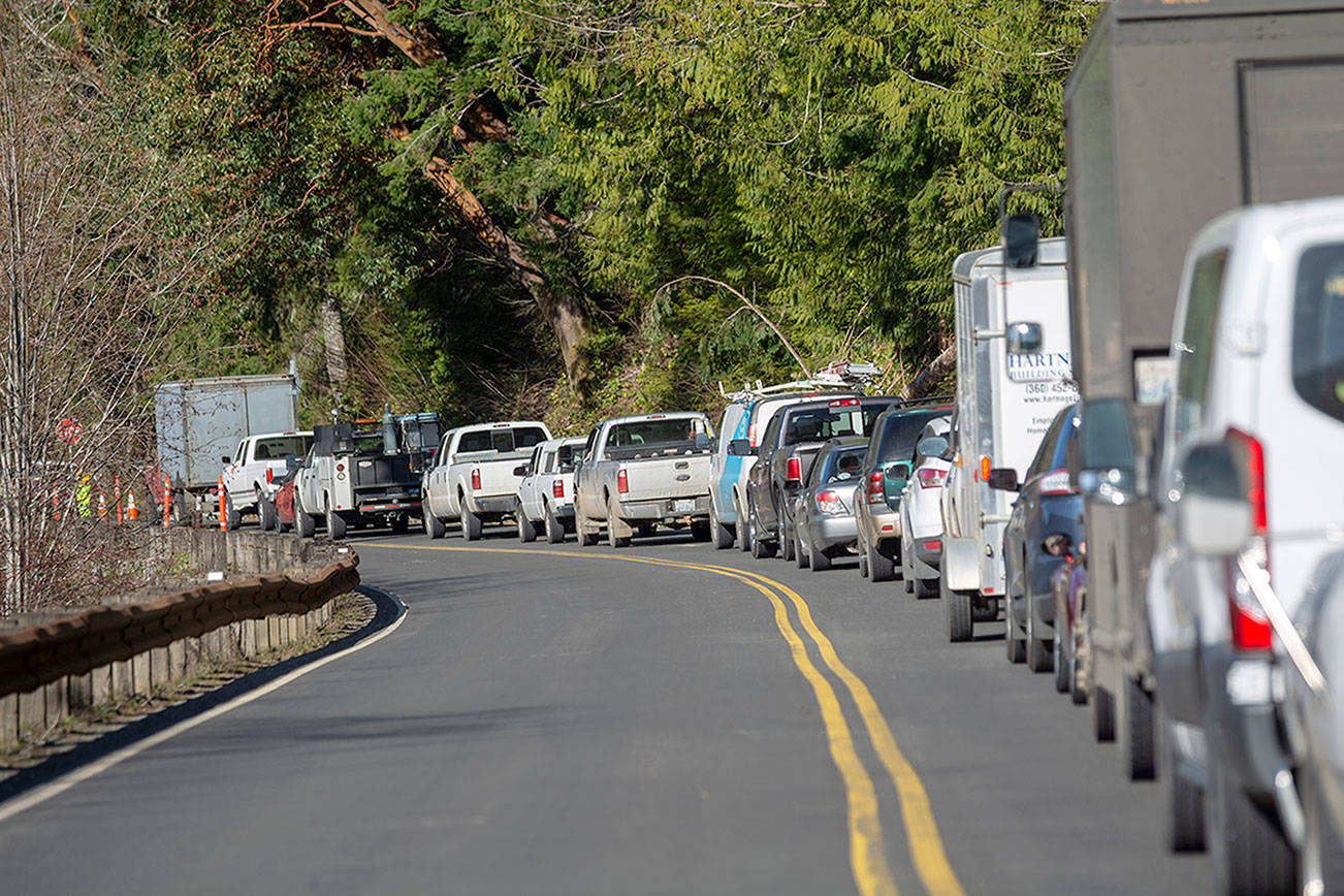 Traffic waits on U.S. Highway 101 around Lake Crescent as crews continue working on the road March 19, 2019. (Jesse Major/Peninsula Daily News)