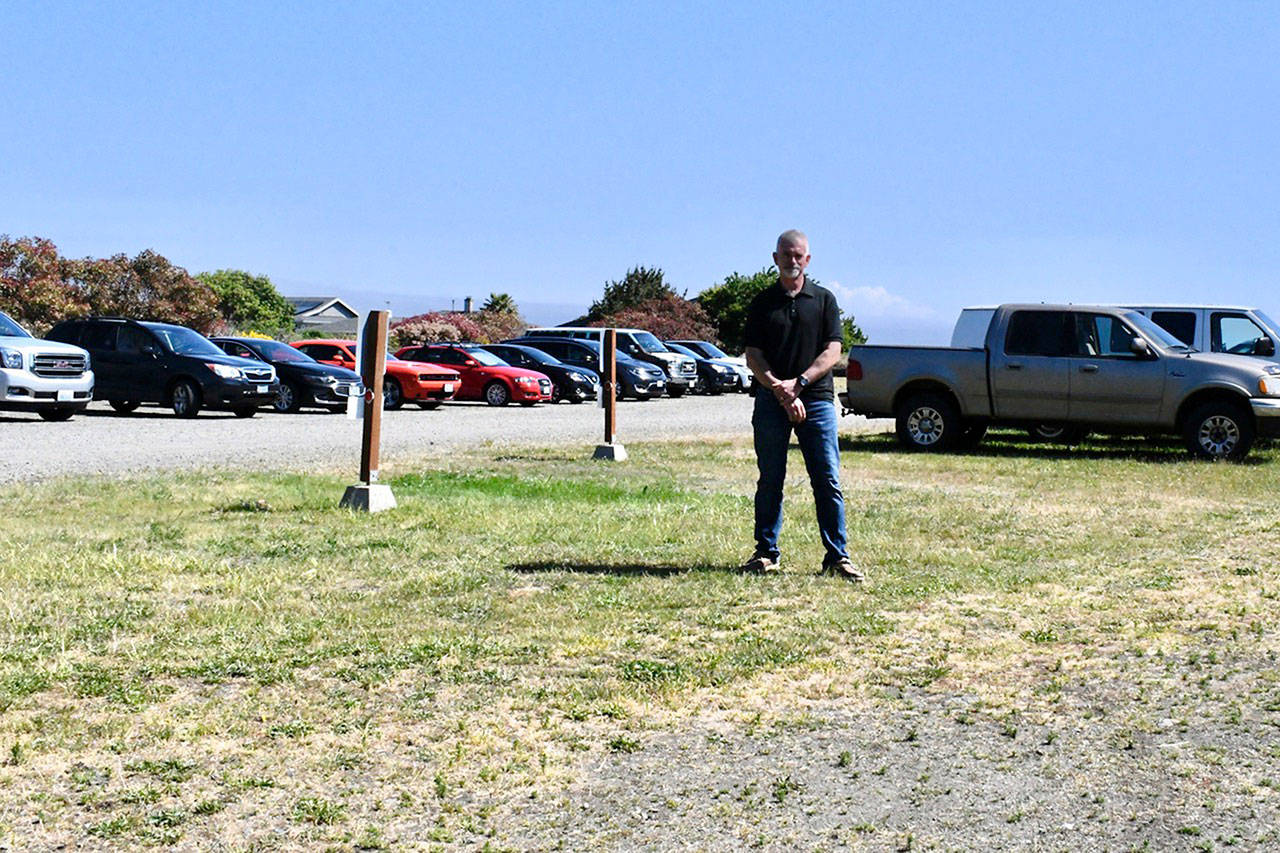 SEA Marine General Manager Chris Bakken stands in the middle of a Point Hudson field which is used as a parking lot for port tenants and vendors during the Wooden Boat Festival and other events. Bakken has asked the port commission for a lease on the property to expand his business. (Jeannie McMacken/Peninsula Daily News)