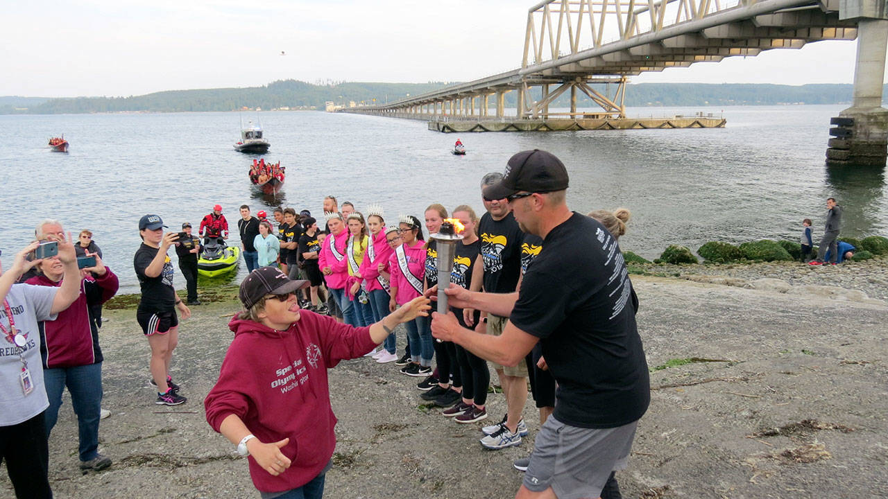 The Special Olympics torch was passed from Jefferson County to Kitsap County torch bearers at Shine Tidelands State Park on Wednesday. The flame was carried across Hood Canal on a Port Gamble S’Klallam Tribe canoe.