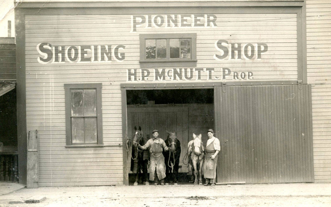 H.P. McNutt, the author’s grandfather, is seen on the right in front of his blacksmith shop near Fourth and Francis Streets in Port Angeles in this undated family photo.