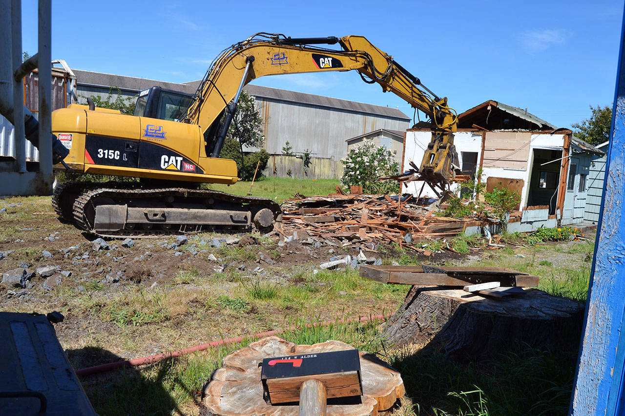 Crewmen with C&J Excavating demolish a home at 154 W. Alder St. in Sequim on May 23 to make room for parking and potentially a new facility for the Sequim Food Bank. (Matthew Nash/Olympic Peninsula News Group)