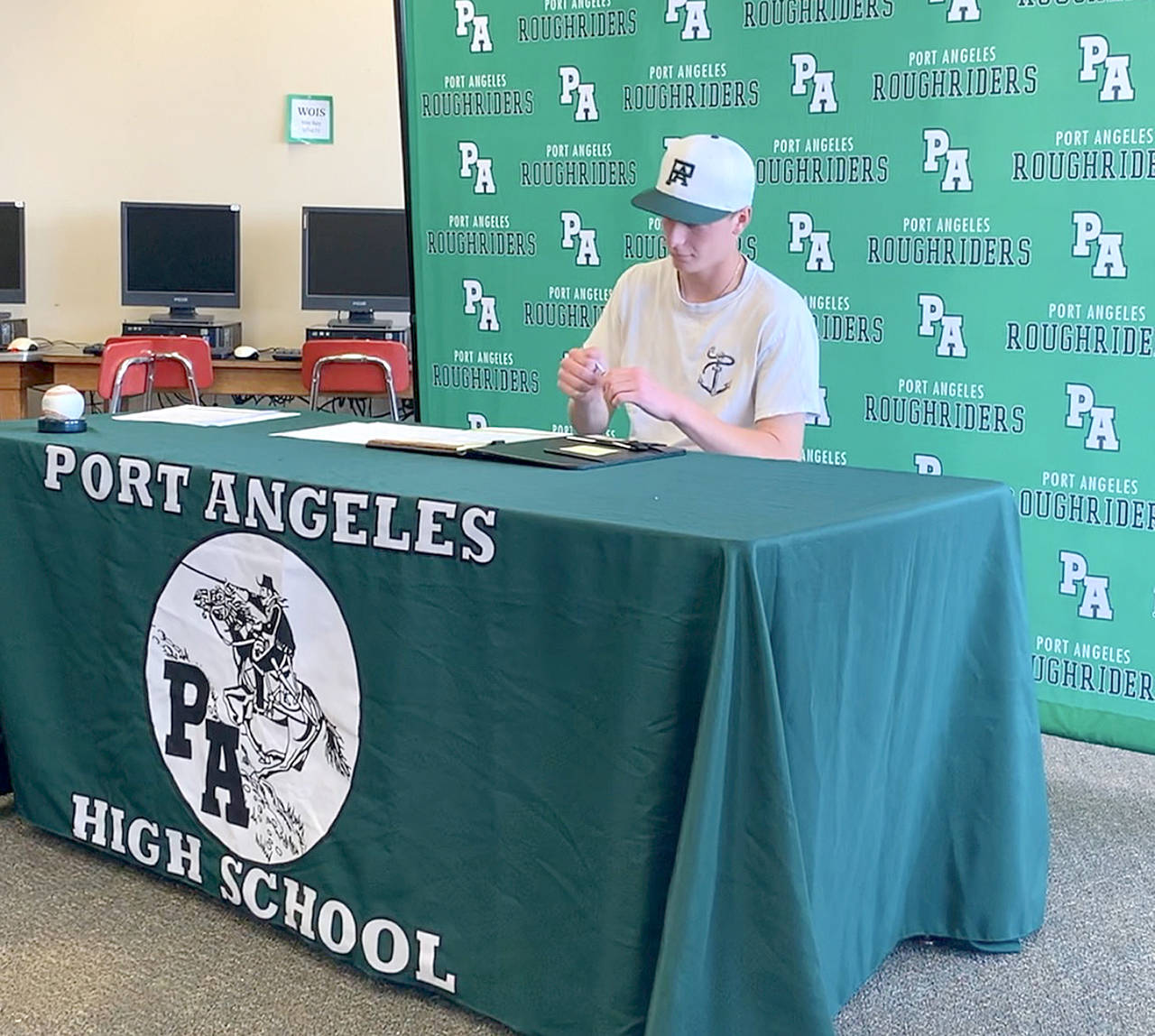 Port Angeles’ pitcher Hayden Woods signed a letter of intent Friday to continue his baseball career at Lower Columbia College in Longview.