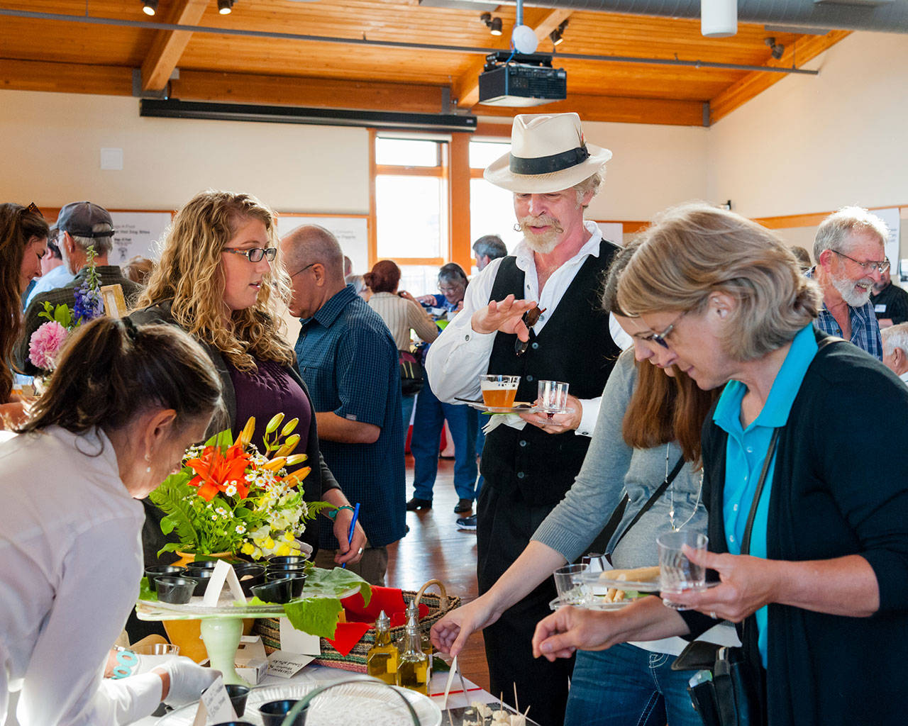 Participants of the 2018 Taste of Port Townsend discuss what they’re trying. (Deja View Photography)