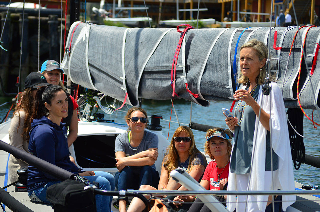 Skipper Jeanne Goussev, far left, and the crew of Team Sail Like a Girl listen as Grace McLeod, far right, begins a blessing ceremony at Point Hudson on Sunday. The team, winner of the 2018 Race to Alaska, is back for another run from Port Townsend to Ketchikan, Alaska. (Diane Urbani de la Paz/for Peninsula Daily News)