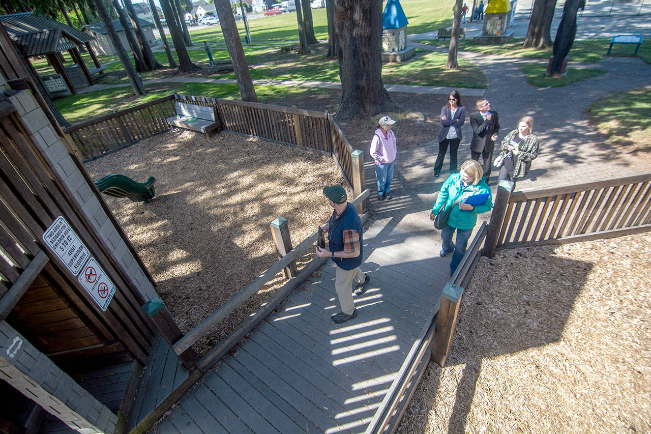 Officials with the city of Port Angeles and Dream Playground Foundation walk through the playground. A conceptual design of the Generation II Dream Playground will be revealed today. (Jesse Major/Peninsula Daily News)