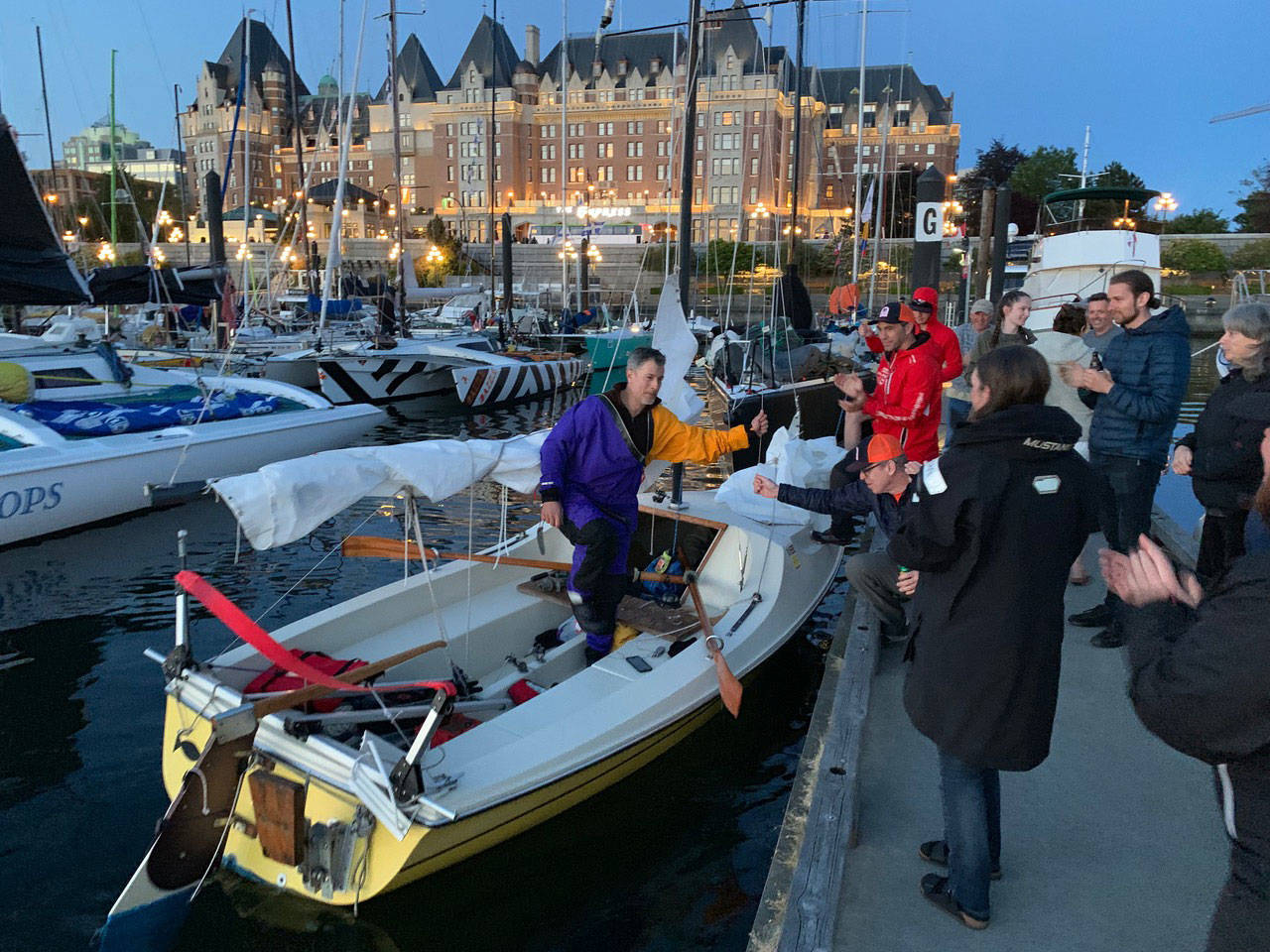 Christian Patrick of Woodside, N.Y., climbs out of his 18-foot sliding seat rower Monday after he reached Victoria, the first leg of the Race to Alaska. Patrick is the lone crew member aboard team Try Baby Tri. (Charley Starr/RaceToAlaska.com)
