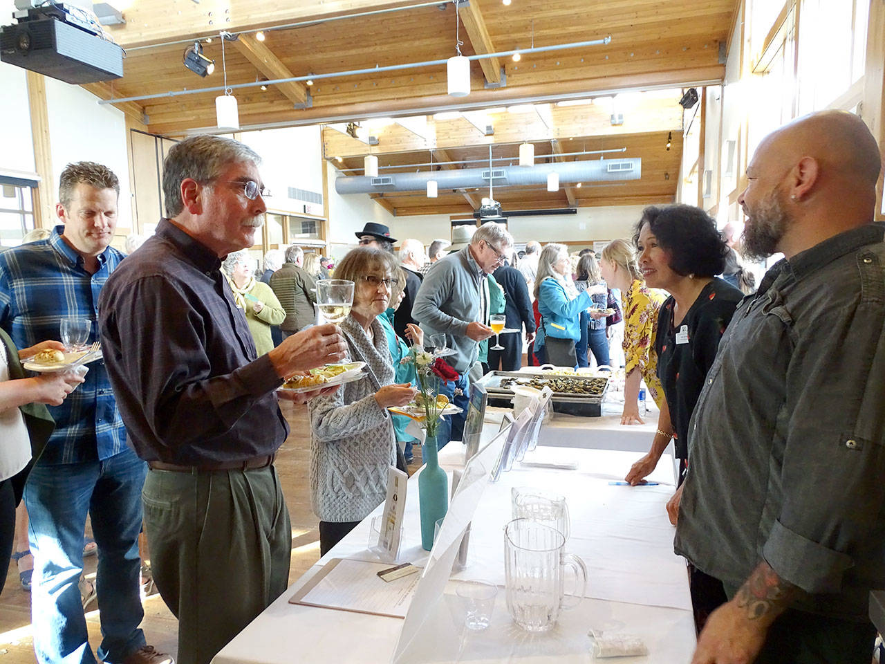 Taste of Port Townsend guests stop by for sips at the Port Townsend Vineyards booth.