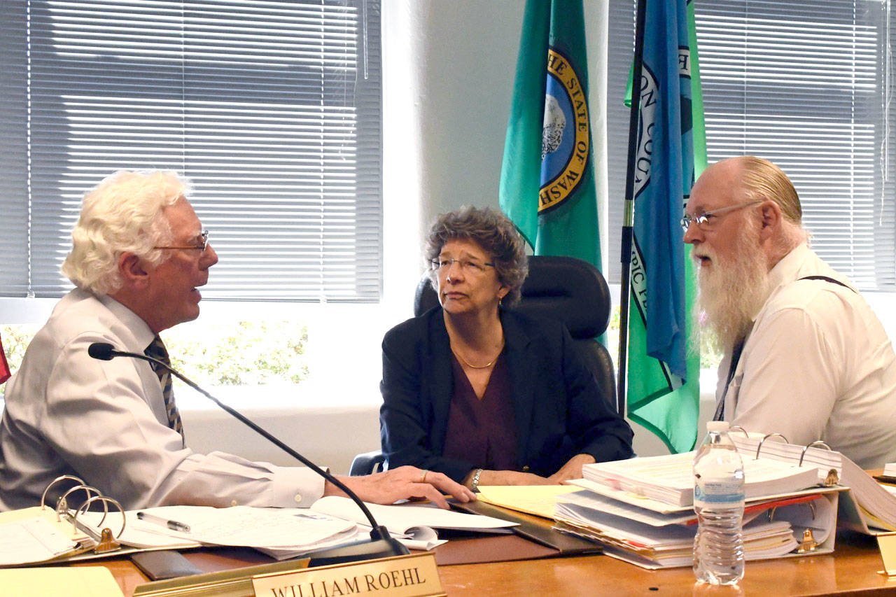 Members of the Growth Management Hearings Board — William Roel, left, President Nina Carter and Bill Hinkle — were in Port Townsend on Tuesday for a hearing on an appeal filed by the Tarboo Ridge Coalition over county shooting range ordinances. (Jeannie McMacken/ Peninsula Daily News)